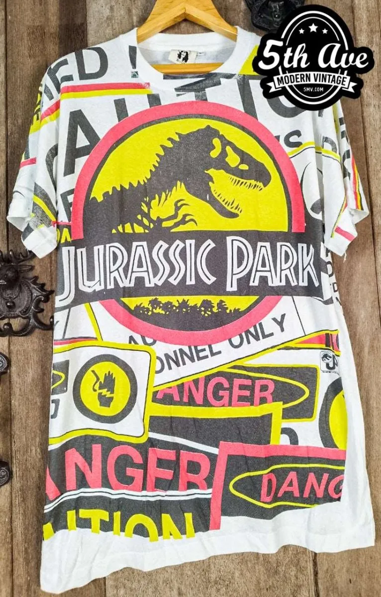 Jurassic Adventure: Distressed Cotton T-Shirt with All-Over Jurassic Park Print and 30-Day Satisfaction Guarantee