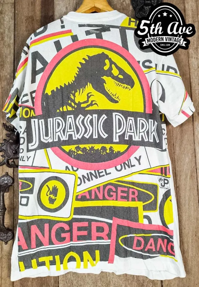 Jurassic Adventure: Distressed Cotton T-Shirt with All-Over Jurassic Park Print and 30-Day Satisfaction Guarantee